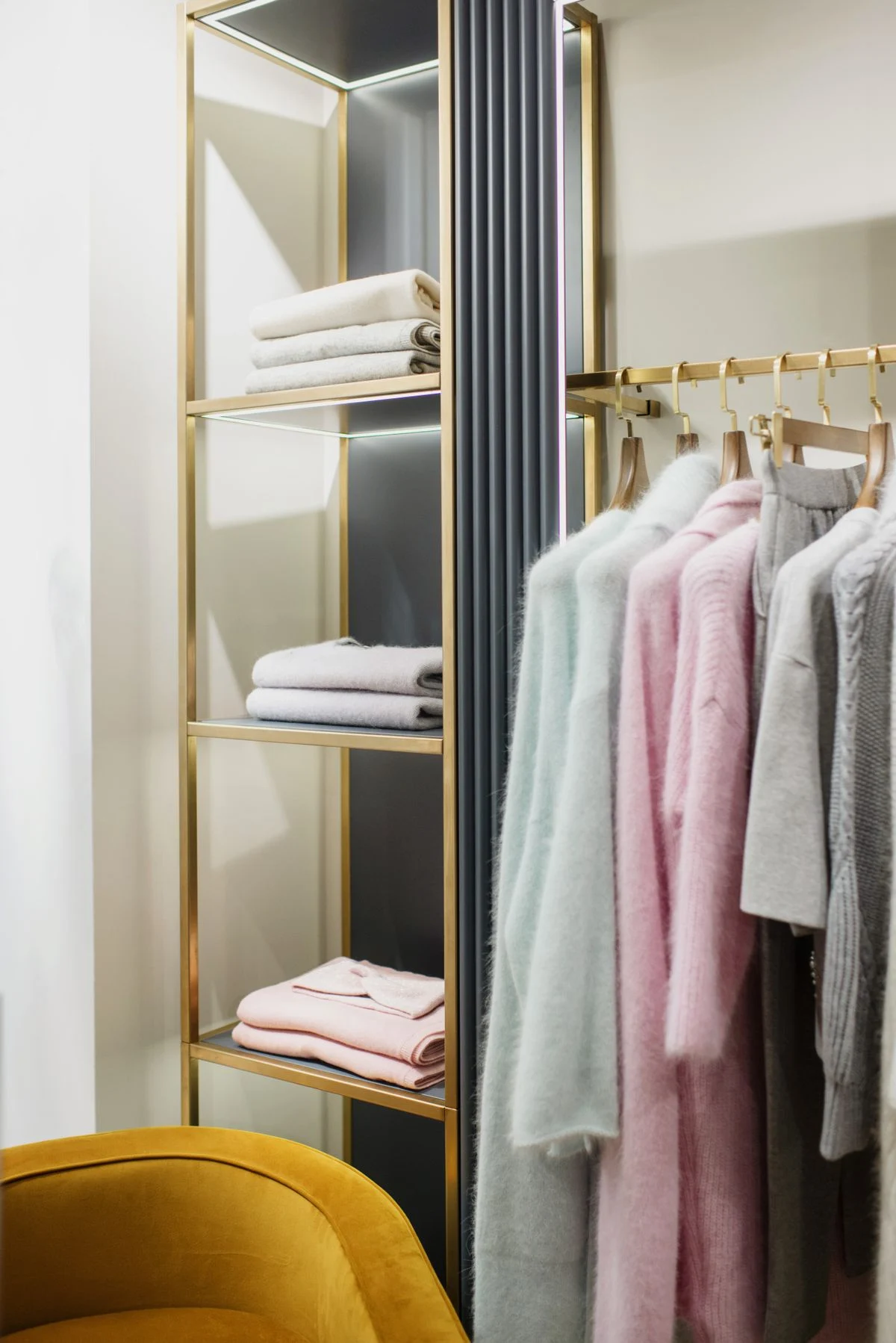 Folded linens and neatly aligned clothing in an orderly wardrobe